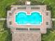 Aerial view of a sparkling community pool with ample lounge chairs and lush green landscaping surrounding the area at 3000 Laurel Park Ln # 202, Kissimmee, FL 34741