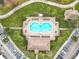 Overhead view of a community pool with ample seating surrounded by green landscaping and walkways with parking nearby at 3000 Laurel Park Ln # 202, Kissimmee, FL 34741