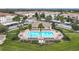 Community pool surrounded by lush greenery, palm trees, and lounge chairs, offering a relaxing outdoor space at 3000 Laurel Park Ln # 202, Kissimmee, FL 34741