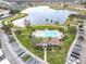 Community view featuring a pool, lake, and fountains, set amidst lush landscaping and convenient parking at 3000 Laurel Park Ln # 202, Kissimmee, FL 34741