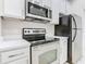 Kitchen featuring stainless steel appliances, sleek countertops and modern fixtures, perfect for cooking and entertaining at 3000 Laurel Park Ln # 202, Kissimmee, FL 34741