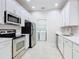 Well-equipped kitchen with stainless steel appliances, ample white cabinetry, and convenient access to laundry closet at 3000 Laurel Park Ln # 202, Kissimmee, FL 34741