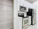 Bright kitchen featuring stainless steel appliances, white cabinetry and walk-in pantry with metal shelving at 3000 Laurel Park Ln # 202, Kissimmee, FL 34741