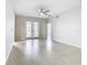 Inviting living room with tiled flooring, ceiling fan, and glass doors leading to the outdoor patio at 3000 Laurel Park Ln # 202, Kissimmee, FL 34741
