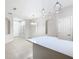 Bright and airy living area with tile floors, recessed lighting, arched wall niches, and a view to the kitchen at 3000 Laurel Park Ln # 202, Kissimmee, FL 34741