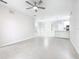 Spacious and well-lit living room with neutral paint, tile flooring, and modern ceiling fan at 3000 Laurel Park Ln # 202, Kissimmee, FL 34741