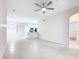 Open-concept living space with tile floors, ceiling fan, and a view of the modern kitchen at 3000 Laurel Park Ln # 202, Kissimmee, FL 34741