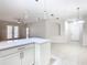 Open-concept living area with tile flooring, modern pendant lights, and access to outdoor balcony at 3000 Laurel Park Ln # 202, Kissimmee, FL 34741