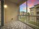 Relaxing screened patio with patterned tile floor, offering a serene view of the lush surroundings and beautiful colorful sunsets at 3000 Laurel Park Ln # 202, Kissimmee, FL 34741