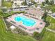 This aerial view features a community pool surrounded by lounge chairs and a covered patio area at 3000 Laurel Park Ln # 202, Kissimmee, FL 34741