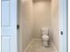 Small toilet room with tiled floors and white toilet at 3000 Laurel Park Ln # 202, Kissimmee, FL 34741