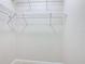 Bright walk-in closet featuring white wire shelving for organized storage solutions at 3000 Laurel Park Ln # 202, Kissimmee, FL 34741