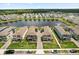 This aerial view showcases neighborhood living with a serene pond, manicured lawns, and convenient parking at 3039 Meleto Blvd, New Smyrna Beach, FL 32168