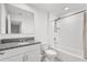 Well-lit bathroom offers a shower over tub, granite counters, and white cabinets at 3039 Meleto Blvd, New Smyrna Beach, FL 32168
