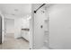 Modern bathroom with shower, tile floors, and white cabinets at 3039 Meleto Blvd, New Smyrna Beach, FL 32168