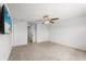 Bedroom with ceiling fan, tv, door to bathroom, and neutral carpet at 3039 Meleto Blvd, New Smyrna Beach, FL 32168
