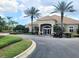 Clubhouse with well-manicured landscaping, towering palm trees, and private parking at 3039 Meleto Blvd, New Smyrna Beach, FL 32168