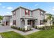 Charming two-story home boasts a modern exterior with red shutters and a well-manicured lawn at 3039 Meleto Blvd, New Smyrna Beach, FL 32168