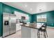 Well-lit kitchen with stainless steel appliances, granite countertops, and barstool seating at 3039 Meleto Blvd, New Smyrna Beach, FL 32168