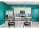Kitchen with white cabinets, granite countertops, stainless steel appliances, and bar seating at 3039 Meleto Blvd, New Smyrna Beach, FL 32168
