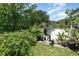 Landscaped backyard featuring a patio with a grill, plants, and various outdoor furniture at 3063 Mandolin Dr, Kissimmee, FL 34744
