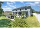 Backyard featuring a home exterior, with a screened porch and solar panels at 3063 Mandolin Dr, Kissimmee, FL 34744