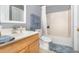 Bright bathroom with tile floors, white vanity, and shower-tub combination at 3063 Mandolin Dr, Kissimmee, FL 34744