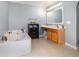 Well-lit bathroom showcasing a garden tub, tile floor, and vanity with mirror at 3063 Mandolin Dr, Kissimmee, FL 34744