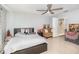Airy bedroom boasting white walls, tile floors, a fan, and an ensuite bathroom at 3063 Mandolin Dr, Kissimmee, FL 34744