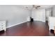 Well-lit bedroom with hardwood floors, white dressers and storage closets and a ceiling fan at 3063 Mandolin Dr, Kissimmee, FL 34744
