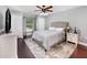Bedroom with hardwood floors, a ceiling fan, and ample closet space for storage at 3063 Mandolin Dr, Kissimmee, FL 34744