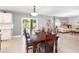 Dining area with wood table and chairs, seamlessly connected to the living room and adjacent to the kitchen at 3063 Mandolin Dr, Kissimmee, FL 34744