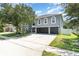 A spacious home featuring a three-car garage, ample driveway space, and attractive curb appeal with a well-kept lawn at 3063 Mandolin Dr, Kissimmee, FL 34744
