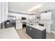 Bright kitchen boasts stainless appliances, gray island, white countertops, and tiled backsplash and flooring at 3063 Mandolin Dr, Kissimmee, FL 34744