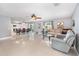 Spacious living area featuring tile flooring, a dining table, and comfortable seating at 3063 Mandolin Dr, Kissimmee, FL 34744