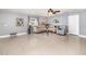 Open-concept living room with tile floors, neutral furniture, and natural light at 3063 Mandolin Dr, Kissimmee, FL 34744