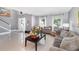 Bright and airy living space features neutral tones, tile floors, staircase, and large windows at 3063 Mandolin Dr, Kissimmee, FL 34744