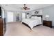 Spacious main bedroom with a ceiling fan, walk-in closets, and neutral decor at 3063 Mandolin Dr, Kissimmee, FL 34744