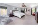 Spacious main bedroom with a ceiling fan, comfortable furniture, including crib, rocking chair and art pieces at 3063 Mandolin Dr, Kissimmee, FL 34744