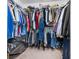 A walk-in closet with wire shelving fully stocked with a variety of clothing at 3063 Mandolin Dr, Kissimmee, FL 34744