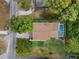 Aerial view of home showing roof, green lawn, mature trees, and screened pool enclosure at 360 Pineview St, Altamonte Springs, FL 32701