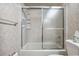 Bathroom featuring a shower-tub combo with sliding glass doors and tiled walls at 360 Pineview St, Altamonte Springs, FL 32701