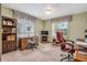 Traditional bedroom features a wooden desk, bookcase, carpeted floor, and light green painted walls at 360 Pineview St, Altamonte Springs, FL 32701