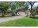 Home exterior features a side-entry garage, long driveway, and lush green lawn at 360 Pineview St, Altamonte Springs, FL 32701