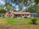 Charming home featuring a well-maintained front yard, stone accents, and mature trees at 360 Pineview St, Altamonte Springs, FL 32701