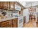 Traditional kitchen with wood cabinets, granite countertops, white appliances, and mosaic backsplash at 360 Pineview St, Altamonte Springs, FL 32701