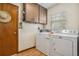Functional laundry room with washer, dryer, cabinets, and a window for natural light at 360 Pineview St, Altamonte Springs, FL 32701