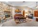 Comfortable living room boasts a stone fireplace, neutral walls, and plush couches at 360 Pineview St, Altamonte Springs, FL 32701
