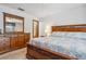 Comfortable main bedroom featuring wood furniture, and a neutral color scheme at 360 Pineview St, Altamonte Springs, FL 32701