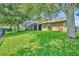 Large backyard featuring a screened patio, a view of neighboring yards, and a sprawling lawn at 369 Torgiano Dr, Ocoee, FL 34761